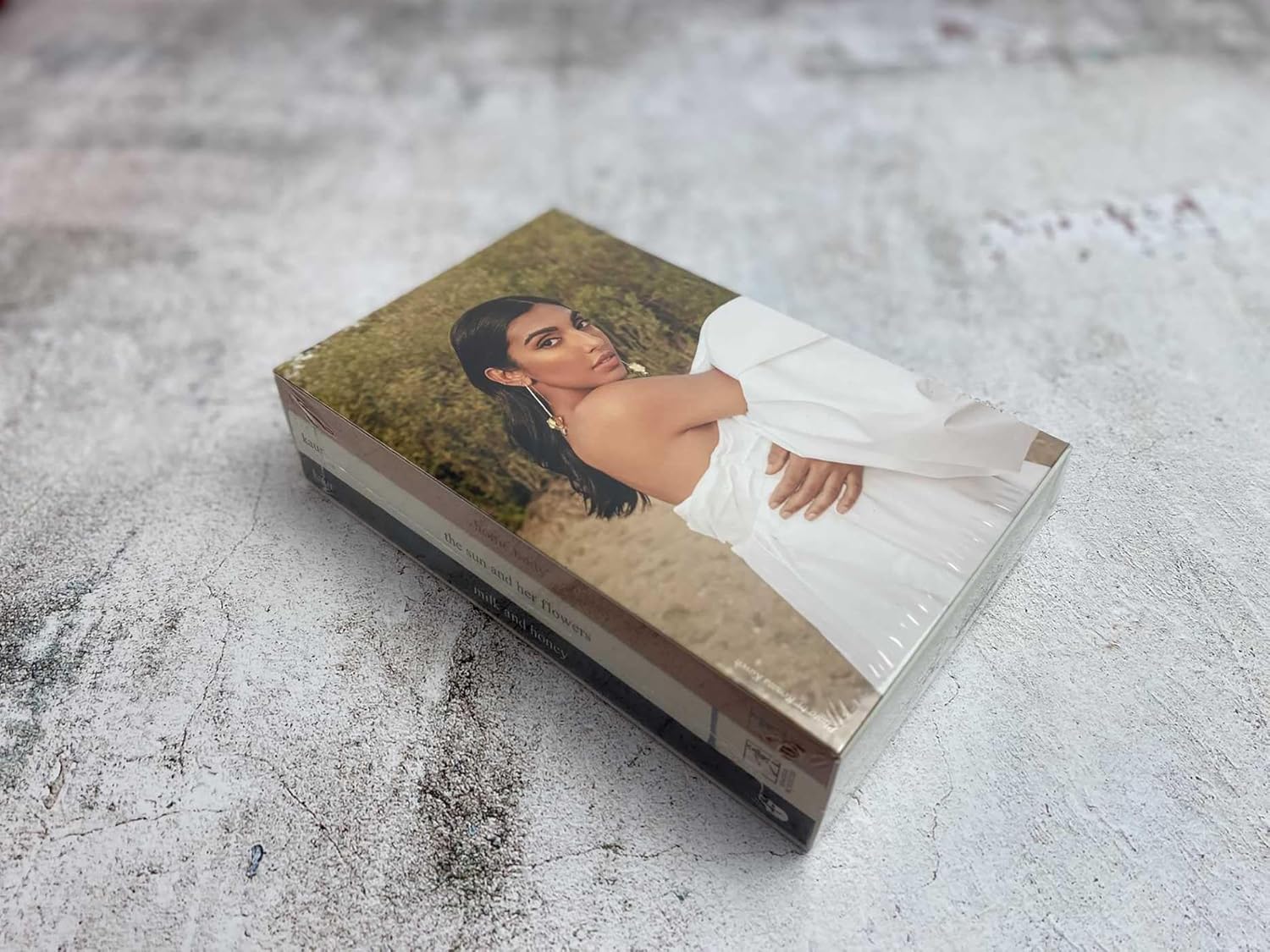 Close-up of Rupi Kaur poetry book on a soft, textured surface – lifestyle image