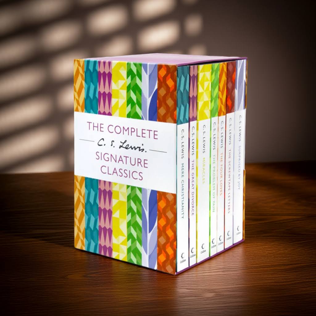 The Complete C. S. Lewis Signature Classics Box Set displayed on a wooden table with soft shadows and warm light – English Books Webshop