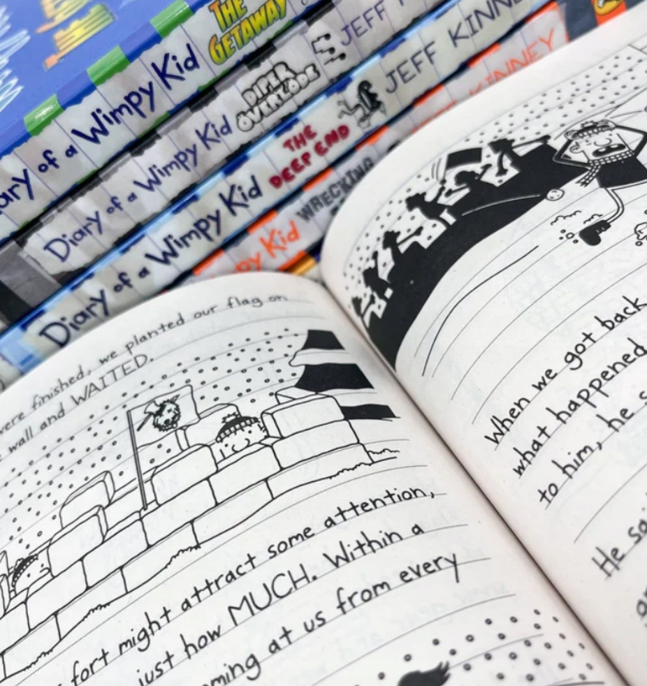 Open book showing illustrations and text, with 'Diary of a Wimpy Kid' books in the background.
