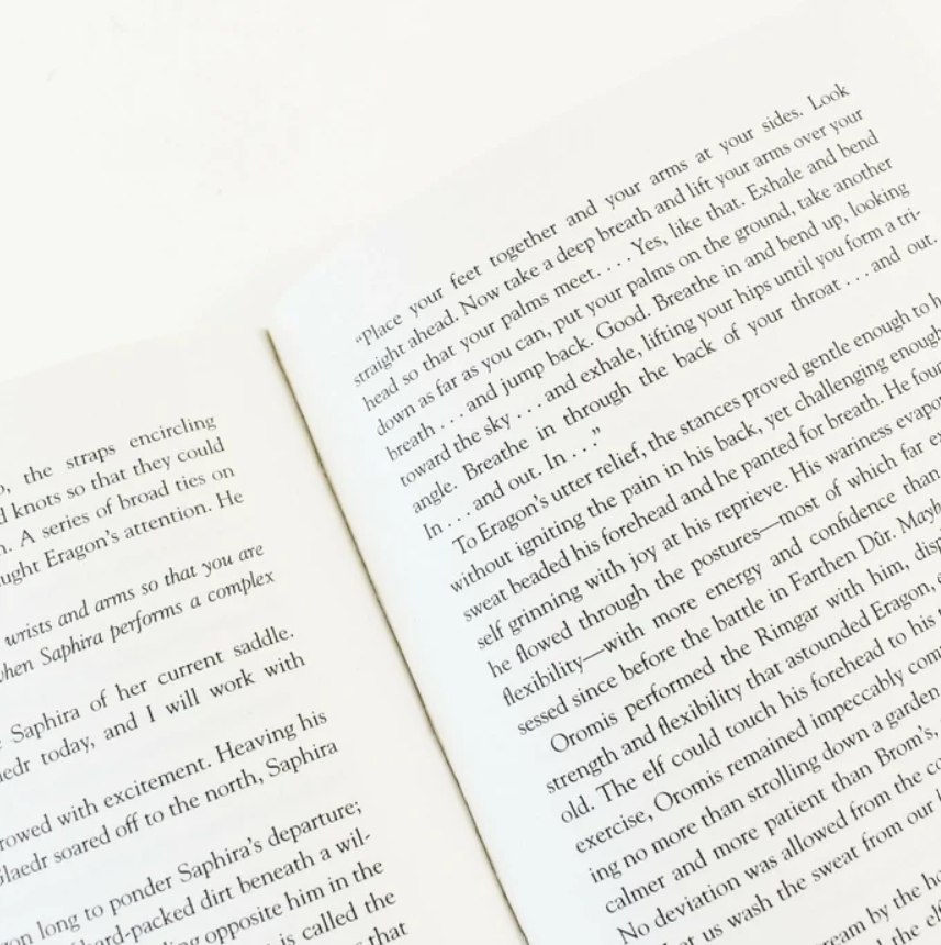 An open book spread showing printed text on both pages, photographed from above at a slight angle against a neutral background.