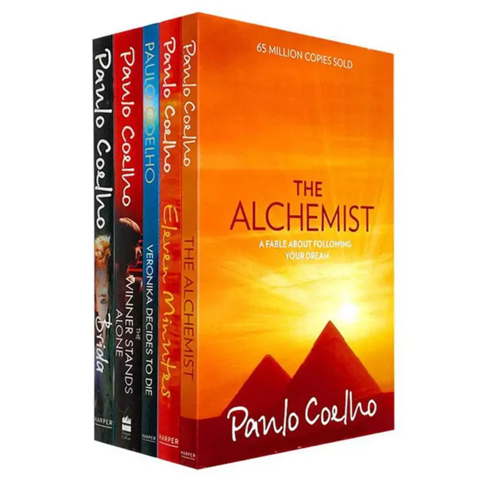 A boxed set of four Paulo Coelho books displayed upright on a white background. The front cover shows the title 'The Alchemist' with a bright orange sky and red pyramid graphic, and the spines show the other titles: 'Sofia', 'The Wind That Moves', 'The Ones Who Died', and 'The Alchemist'.