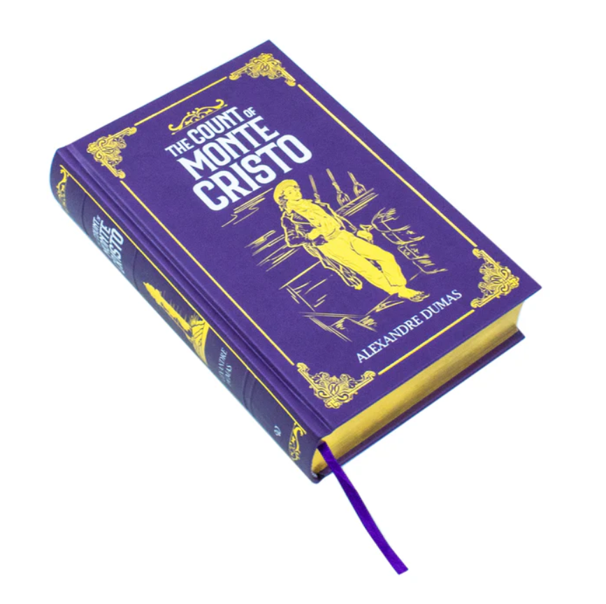 Purple book titled 'The Count of Monte Cristo' by Alexandre Dumas on a white background