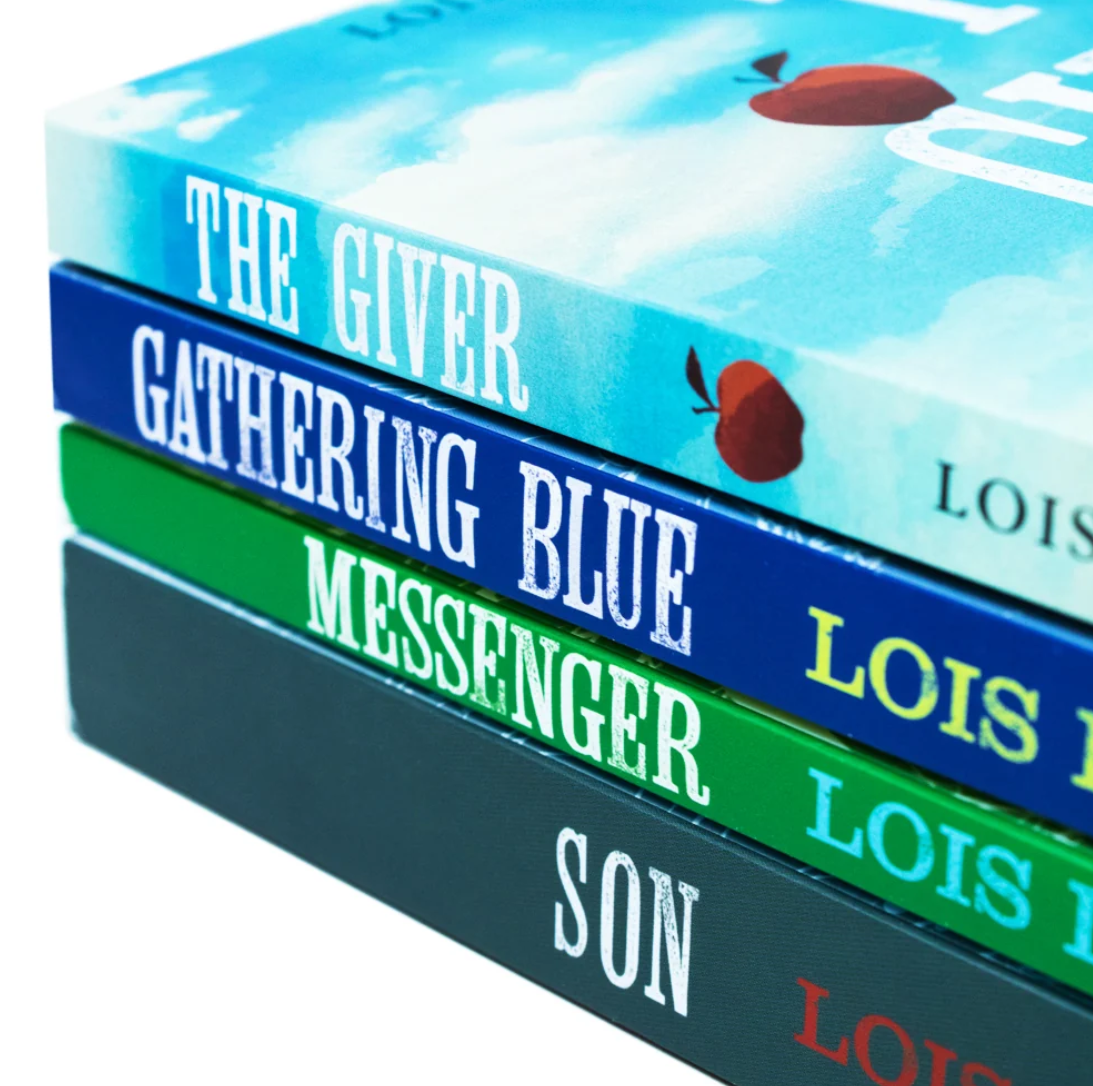 A close-up stack of four Lois Lowry novels on a white background: The Giver, Gathering Blue, Messenger, and Son, with their colorful book spines visible.
