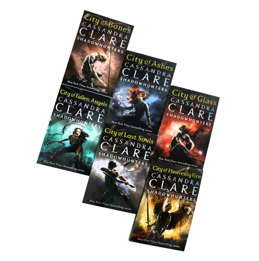 Six paperback book covers from Cassandra Clare's Shadowhunters series arranged diagonally on a white background. The books include City of Bones, City of Ashes, City of Fallen Angels, City of Lost Souls, City of Glass, and City of Heavenly Fire.