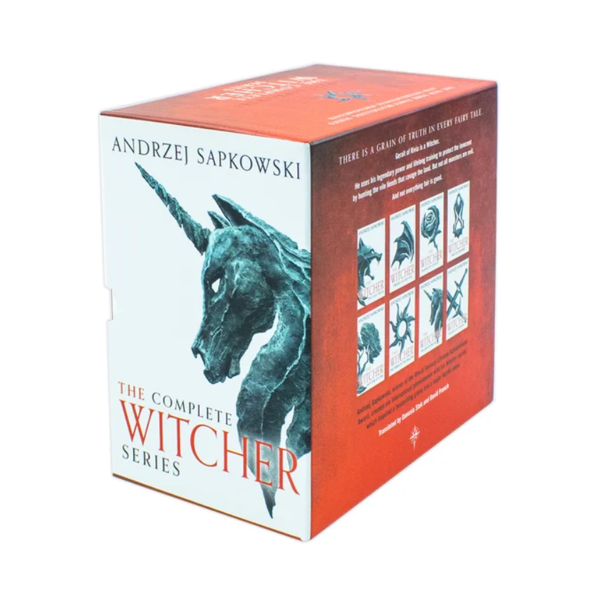 The Complete Witcher Series box set by Andrzej Sapkowski, featuring a white and red box with illustrations of a unicorn and card art on the side, photographed on a plain white background.