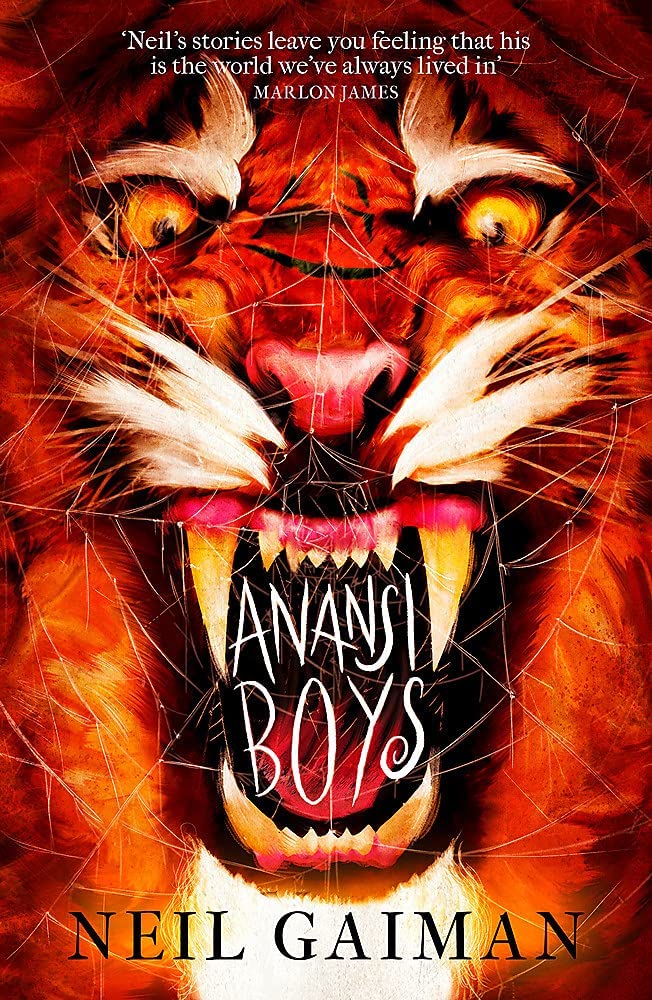 Book cover of 'Anansi Boys' by Neil Gaiman featuring a tiger's face with glowing eyes.