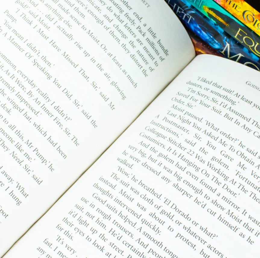 Open book with text on a white surface