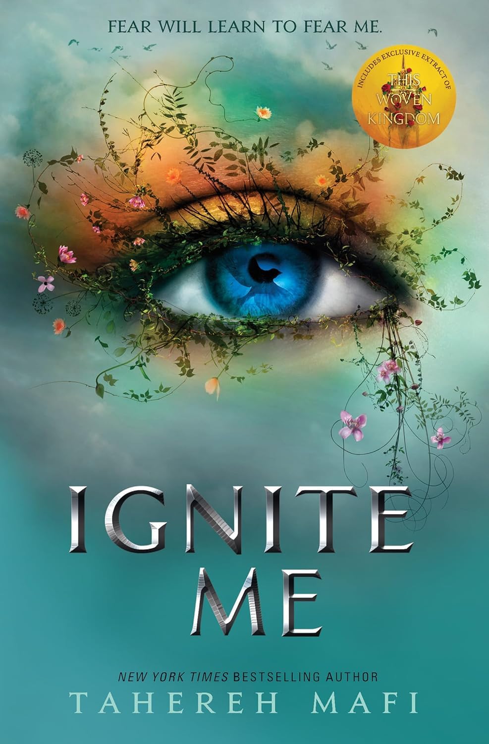 Book cover for 'Ignite Me' by Tahereh Mafi, featuring a large blue eye surrounded by green vines and small pink flowers against a teal and orange gradient background, with the title in large metallic letters at the bottom.