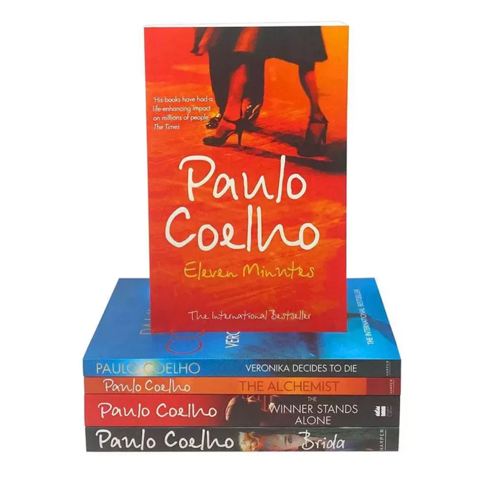 A stack of Paulo Coelho books on a white background, with the top book, 'Eleven Minutes,' standing upright in front of a stack of four other books.